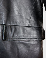 Introducing our Vintage 90s black long leather button coat! Timeless, sleek, and classic, this coat is the perfect addition to any wardrobe. Featuring a button closure, it exudes elegance.