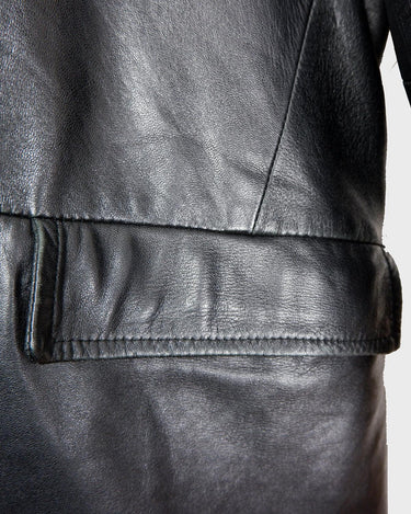 Introducing our Vintage 90s black long leather button coat! Timeless, sleek, and classic, this coat is the perfect addition to any wardrobe. Featuring a button closure, it exudes elegance.