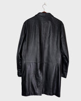 Introducing our Vintage 90s black long leather button coat! Timeless, sleek, and classic, this coat is the perfect addition to any wardrobe. Featuring a button closure, it exudes elegance.