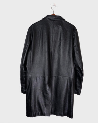Introducing our Vintage 90s black long leather button coat! Timeless, sleek, and classic, this coat is the perfect addition to any wardrobe. Featuring a button closure, it exudes elegance.