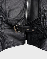 Unleash your inner badass with this Vintage 80s black biker leather jacket. The edgy look is complete with a belted waist and light shoulder pads, making it the perfect statement piece for spring. Crafted from light leather, it provides style and comfort.