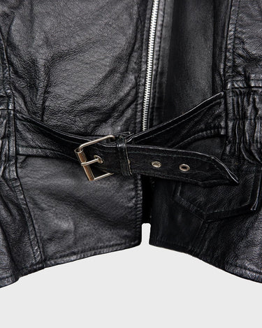 Unleash your inner badass with this Vintage 80s black biker leather jacket. The edgy look is complete with a belted waist and light shoulder pads, making it the perfect statement piece for spring. Crafted from light leather, it provides style and comfort.