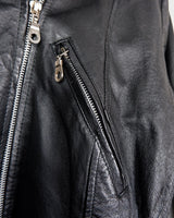 Unleash your inner badass with this Vintage 80s black biker leather jacket. The edgy look is complete with a belted waist and light shoulder pads, making it the perfect statement piece for spring. Crafted from light leather, it provides style and comfort.
