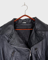 Unleash your inner badass with this Vintage 80s black biker leather jacket. The edgy look is complete with a belted waist and light shoulder pads, making it the perfect statement piece for spring. Crafted from light leather, it provides style and comfort.