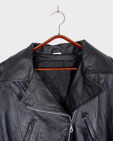 Unleash your inner badass with this Vintage 80s black biker leather jacket. The edgy look is complete with a belted waist and light shoulder pads, making it the perfect statement piece for spring. Crafted from light leather, it provides style and comfort.