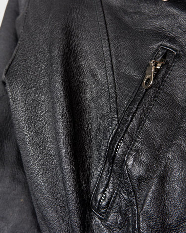 Unleash your inner badass with this Vintage 80s black biker leather jacket. The edgy look is complete with a belted waist and light shoulder pads, making it the perfect statement piece for spring. Crafted from light leather, it provides style and comfort.