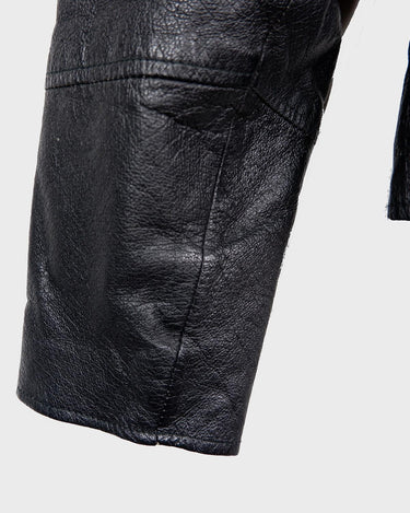 Unleash your inner badass with this Vintage 80s black biker leather jacket. The edgy look is complete with a belted waist and light shoulder pads, making it the perfect statement piece for spring. Crafted from light leather, it provides style and comfort.