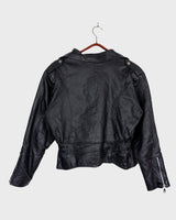 Unleash your inner badass with this Vintage 80s black biker leather jacket. The edgy look is complete with a belted waist and light shoulder pads, making it the perfect statement piece for spring. Crafted from light leather, it provides style and comfort.