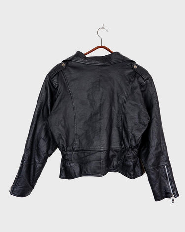Unleash your inner badass with this Vintage 80s black biker leather jacket. The edgy look is complete with a belted waist and light shoulder pads, making it the perfect statement piece for spring. Crafted from light leather, it provides style and comfort.