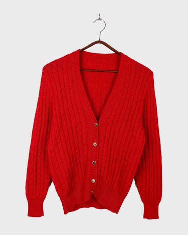 Add a pop of elegance to any outfit with this vintage 80s red cable knit cardigan. The statement red color makes a bold fashion statement.