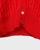 Add a pop of elegance to any outfit with this vintage 80s red cable knit cardigan. The statement red color makes a bold fashion statement.