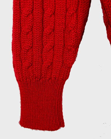 Add a pop of elegance to any outfit with this vintage 80s red cable knit cardigan. The statement red color makes a bold fashion statement.