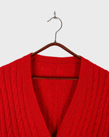 Add a pop of elegance to any outfit with this vintage 80s red cable knit cardigan. The statement red color makes a bold fashion statement.
