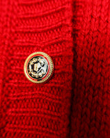 Add a pop of elegance to any outfit with this vintage 80s red cable knit cardigan. The statement red color makes a bold fashion statement.