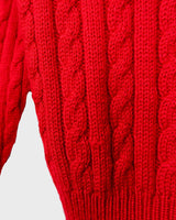 Add a pop of elegance to any outfit with this vintage 80s red cable knit cardigan. The statement red color makes a bold fashion statement.
