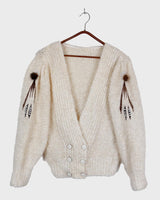 Get ready to cozy up with this vintage 80s boho-style cardigan! Crafted from a mohair mix, this playful cardigan features real fur balls for a unique twist