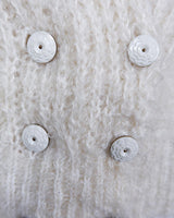 Get ready to cozy up with this vintage 80s boho-style cardigan! Crafted from a mohair mix, this playful cardigan features real fur balls for a unique twist