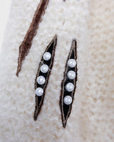 Get ready to cozy up with this vintage 80s boho-style cardigan! Crafted from a mohair mix, this playful cardigan features real fur balls for a unique twist