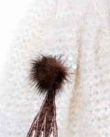 Get ready to cozy up with this vintage 80s boho-style cardigan! Crafted from a mohair mix, this playful cardigan features real fur balls for a unique twist