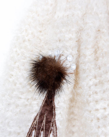 Get ready to cozy up with this vintage 80s boho-style cardigan! Crafted from a mohair mix, this playful cardigan features real fur balls for a unique twist