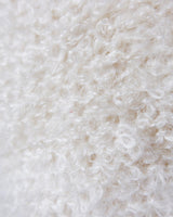 Get ready to cozy up with this vintage 80s boho-style cardigan! Crafted from a mohair mix, this playful cardigan features real fur balls for a unique twist