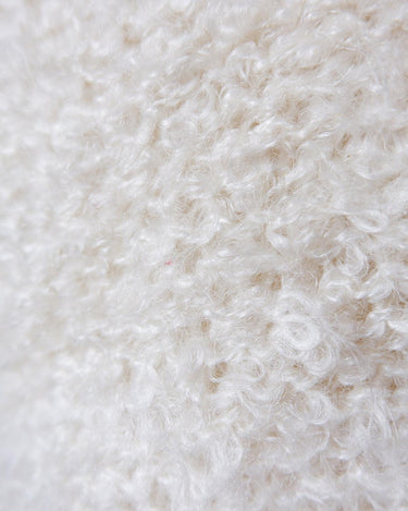 Get ready to cozy up with this vintage 80s boho-style cardigan! Crafted from a mohair mix, this playful cardigan features real fur balls for a unique twist