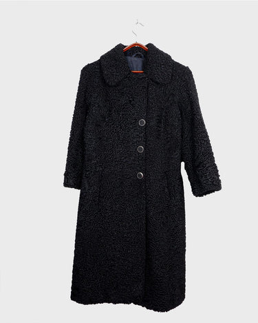 Wrap yourself in elegance with this vintage 80s 90s black real fur coat. This timeless piece adds a touch of luxury to any outfit. 