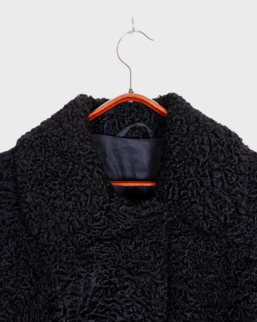 Wrap yourself in elegance with this vintage 80s 90s black real fur coat. This timeless piece adds a touch of luxury to any outfit. 