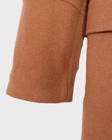 Get ready to slay the Y2k trend with this brown woolmix spring coat! Featuring a luxurious real fur collar, this coat is for everyone who loves to be elegant.