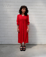 Score a two-for-one with this red 90s vintage gem! A lightweight spring coat that totally transitions to a slick dress when you put on f.e some cycling shorts. Take your transitional looks to the next level!