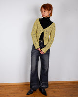 Add some playful personality to your wardrobe with this handmade beige and shimmering yellow cardigan. The light crop fit makes it perfect for layering over any outfit.