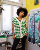 This handmade knit vest in rich green and cream tones is a true eye-catcher. Crafted from wool blend yarn and finished with natural wooden buttons, it blends cozy texture with bold design. The chunky crochet style and timeless check pattern make it perfect for layering.