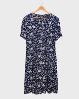 Dress to impress in this vintage 90s blue midi dress with a floral pattern! Tie it tighter for an S-M fit or let it go for a L-XL! Get yours now and get dressed to express!
