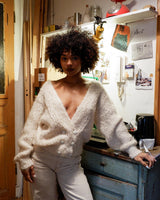 Get ready to cozy up with this vintage 80s boho-style cardigan (thin fabric)! Crafted from a mohair mix, this playful cardigan features real fur balls for a unique twist.