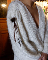 Get ready to cozy up with this vintage 80s boho-style cardigan (thin fabric)! Crafted from a mohair mix, this playful cardigan features real fur balls for a unique twist.