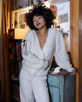 Get ready to cozy up with this vintage 80s boho-style cardigan (thin fabric)! Crafted from a mohair mix, this playful cardigan features real fur balls for a unique twist.