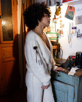 Get ready to cozy up with this vintage 80s boho-style cardigan (thin fabric)! Crafted from a mohair mix, this playful cardigan features real fur balls for a unique twist.