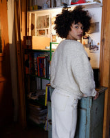 Get ready to cozy up with this vintage 80s boho-style cardigan (thin fabric)! Crafted from a mohair mix, this playful cardigan features real fur balls for a unique twist.