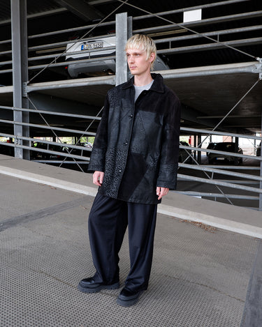 Vintage 80s black leather coat with patchwork design, textured dot panels and shoulder pads | L-XL