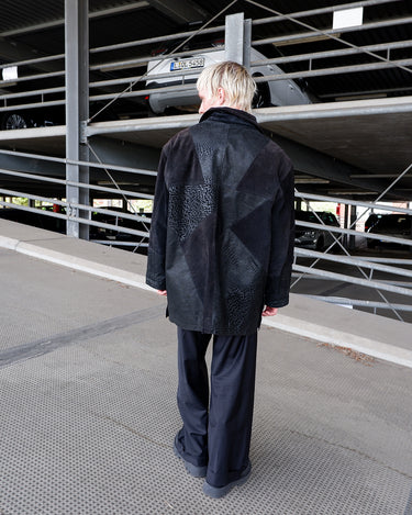 Vintage 80s black leather coat with patchwork design, textured dot panels and shoulder pads | L-XL