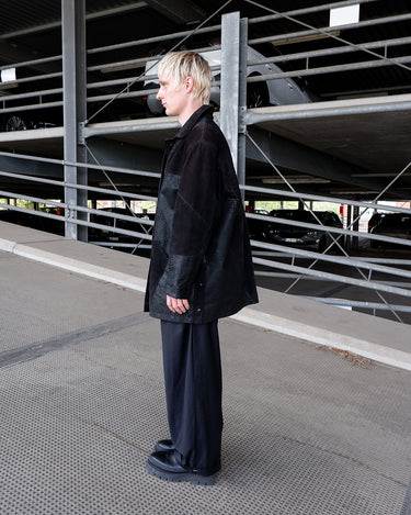 Vintage 80s black leather coat with patchwork design, textured dot panels and shoulder pads | L-XL