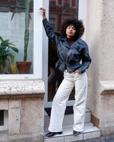 Unleash your inner badass with this Vintage 80s black biker leather jacket. The edgy look is complete with a belted waist and light shoulder pads, making it the perfect statement piece for spring. Crafted from light leather, it provides style and comfort.