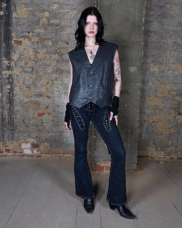 Rock your vintage style with our 90s grey leather vest! This unique piece features a playful paisley pattern at the back for a touch of fun.