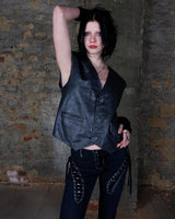 Rock your vintage style with our 90s grey leather vest! This unique piece features a playful paisley pattern at the back for a touch of fun.
