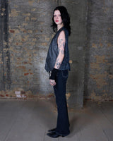 Rock your vintage style with our 90s grey leather vest! This unique piece features a playful paisley pattern at the back for a touch of fun.