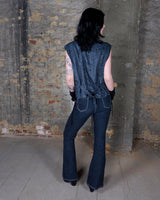 Rock your vintage style with our 90s grey leather vest! This unique piece features a playful paisley pattern at the back for a touch of fun.