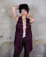 This burgundy leather vest is a vintage gem from the 80s, featuring unique stitching flowers and a boho-style cut. With no closure, it's perfect for layering over any outfit!