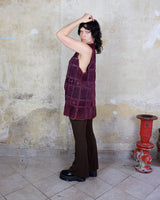 This burgundy leather vest is a vintage gem from the 80s, featuring unique stitching flowers and a boho-style cut. With no closure, it's perfect for layering over any outfit!