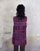 This burgundy leather vest is a vintage gem from the 80s, featuring unique stitching flowers and a boho-style cut. With no closure, it's perfect for layering over any outfit!