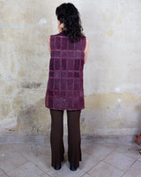 This burgundy leather vest is a vintage gem from the 80s, featuring unique stitching flowers and a boho-style cut. With no closure, it's perfect for layering over any outfit!